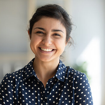 Cheerful Indian Girl Standing At Home Office Looking At Camera